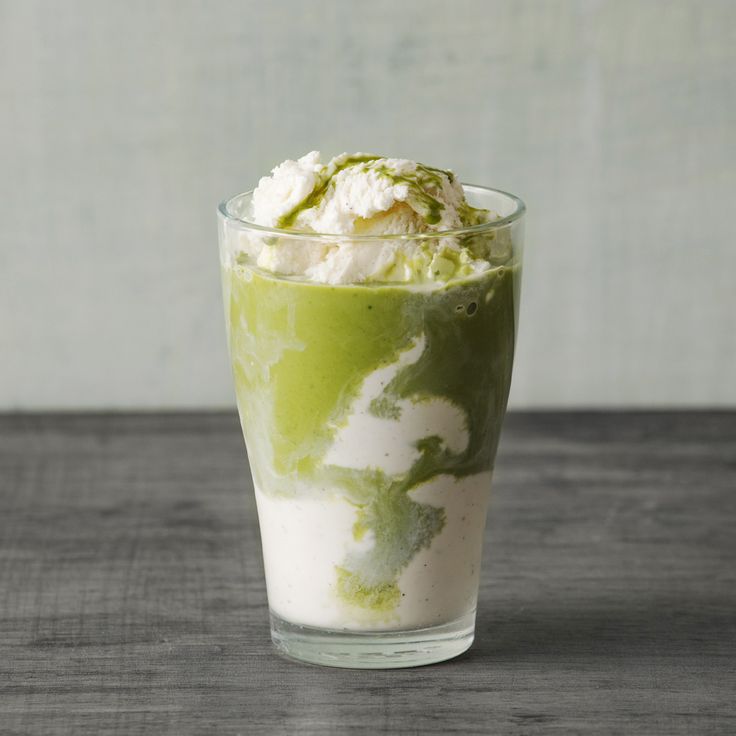 a green drink with whipped cream on top