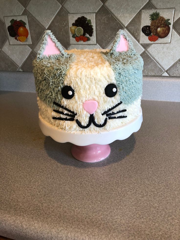 a cake shaped like a cat sitting on top of a counter