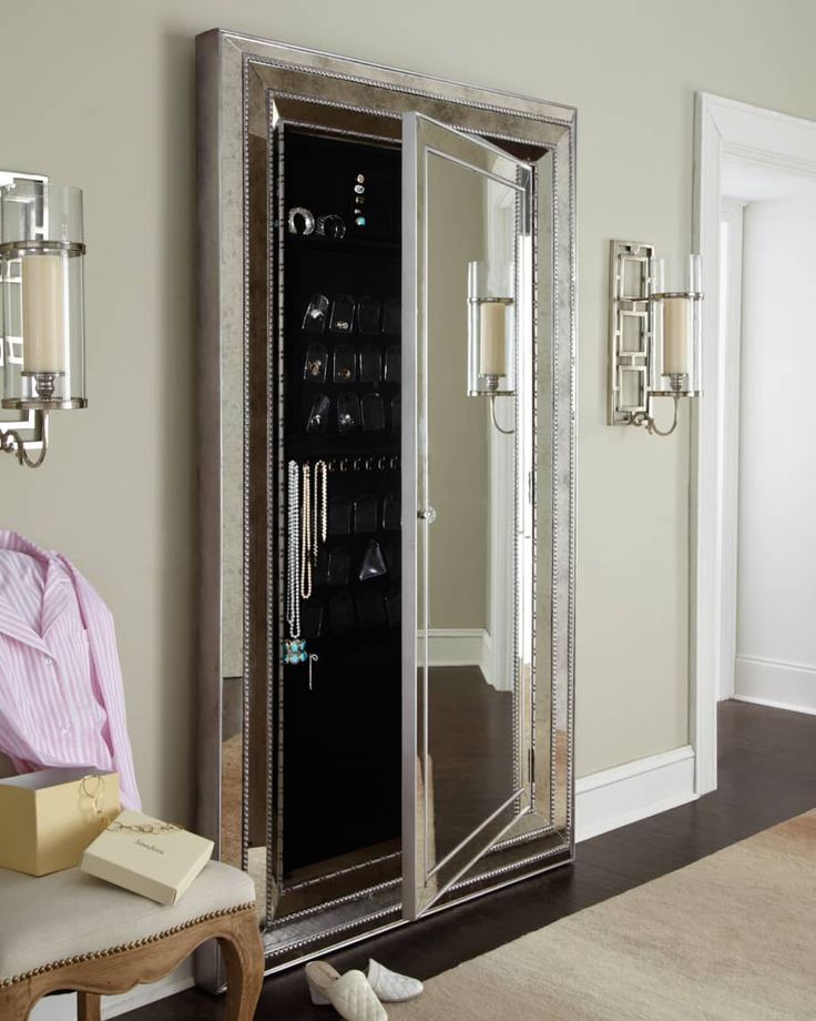 a large mirrored cabinet in the corner of a room