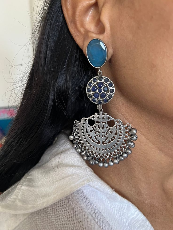 Premium Quality, Silver Replica at its best. Complement your personality with this gorgeous Earrings. Handcrafted in brass, oxidized, stones The weight of the Earrings is 38 grams per pair. The length of the earrings is 10 cm. The width of the earrings is 5 cm. Fusion Style Chandbali Jewelry With Oxidized Finish, Fusion Style Metal Earrings With Latkans, Oxidized Metal Drop Chandelier Earrings, Oxidized Brass Jhumkas, Fusion Style Metal Chandbalis, Oxidized Metal Temple Jewelry Earrings, Bohemian Earrings With Oxidized Finish For Festivals, Oxidized Metal Fusion Jhumkas, Festive Brass Earrings With Oxidized Finish