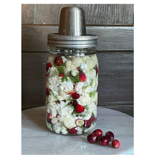 a mason jar filled with flowers and cherries