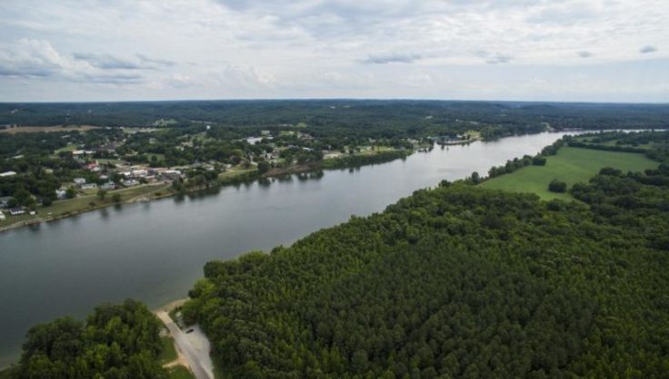 an aerial view of a lake surrounded by trees