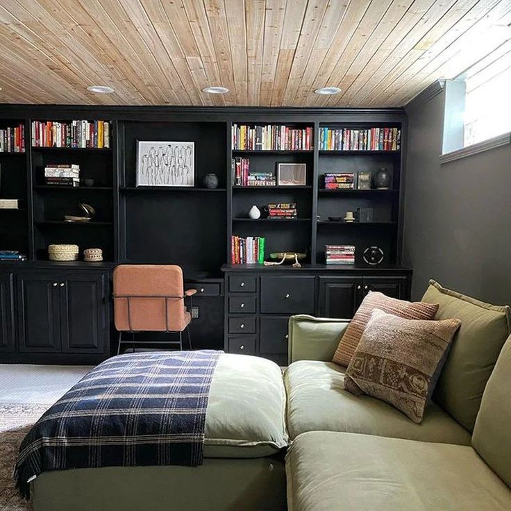 a living room filled with furniture and bookshelves