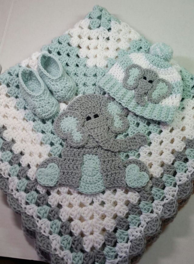 a crocheted baby blanket with an elephant on it