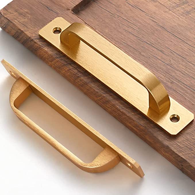 a close up of a wooden door handle on a white surface with wood and brass hardware