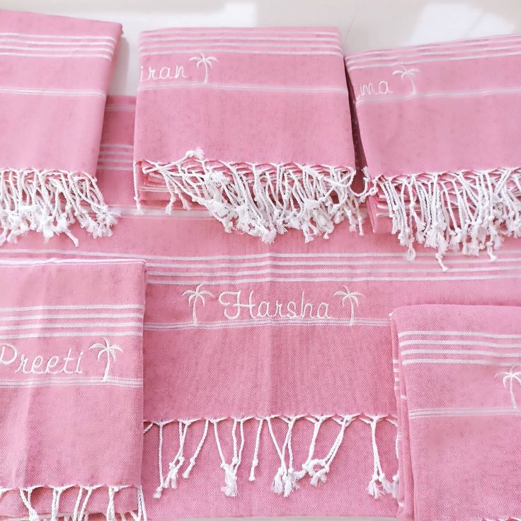 pink towels with embroidered names on them