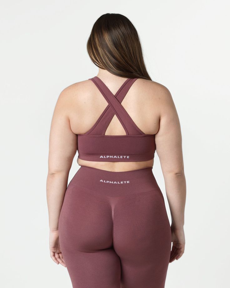 HIGHLIGHTS. Removable cups. Scrunch detailing in the center. Medium to high impact. Moisture-wicking, breathable fabric. V-shaped neckline and crossing back straps. Unbelievably soft texture. Proprietary seamless blend of fine Italian yarn. Alphalete core wordmark knitted in white. Reinforced binding arm and neckline finishing FIT SUGGESTION. This item has a compression fit.. If you are between sizes, we recommend sizing up.. Model is 5’11”/180.3cm, wearing a size L with a 42.5”/108cm bust.. MAT Neckline Finishing, Soft Texture, Back Strap, V Shape, Moisture Wicking, Breathable Fabric, Bra, How To Wear