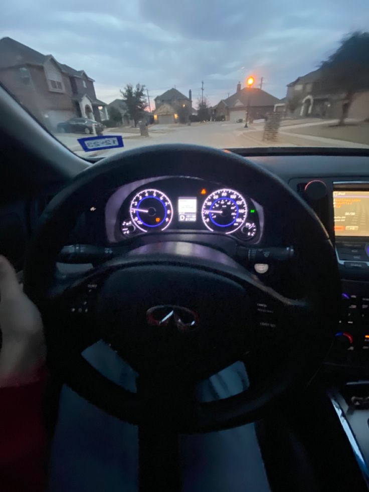 the dashboard of a car is lit up at night