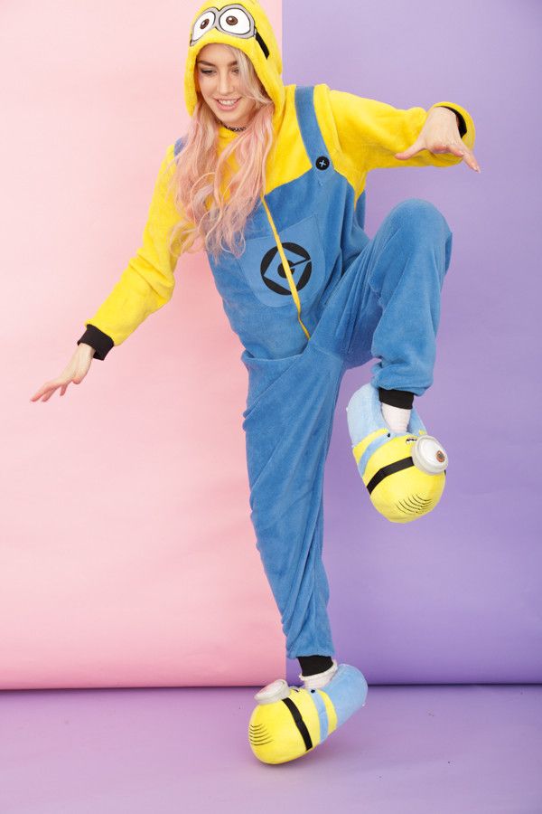 a woman in a yellow and blue costume is doing a dance move with her hands