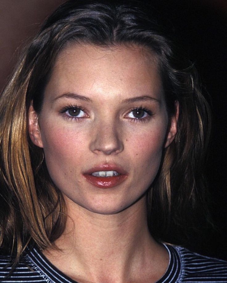 a close up of a person wearing a striped shirt