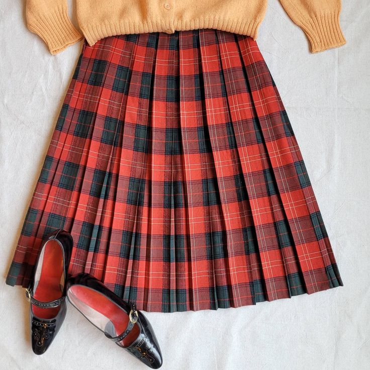 "Brand: handmade  Size: 26\" waist Color: red/green/white  Fabric Content: wool   Features:  Made in a lightweight woven wool fabric, this cute plaid skirt has box plates that run the length of the skirt. The waistband is one inch, and the closer is a zipper button combo.    Measurements:  Waist: 26in  Hip: 32in  Center Back Length: 25in    Condition: Good vintage condition with normal signs of wear, including some small, unnoticeable stains (see photos).   Care: Dry clean only  Vintage sizing varies. Please check your measurements thoroughly and ask any questions before your purchase. No returns or exchanges. Condition is noted in the product description and can be observed using the zoom feature on the photos. We are happy to send further measurements or photos upon request. Eclectriciti Fitted Plaid Skirt For School, Fitted Plaid Preppy Skirt, Preppy Skirt For School In Fall, Preppy School Skirt For Fall, Preppy Fall School Skirt, Fitted Plaid Skirt For School Uniform, Preppy Plaid Skirt For School, Preppy Plaid School Skirt, Plaid Pleated Skirt For School In Fall