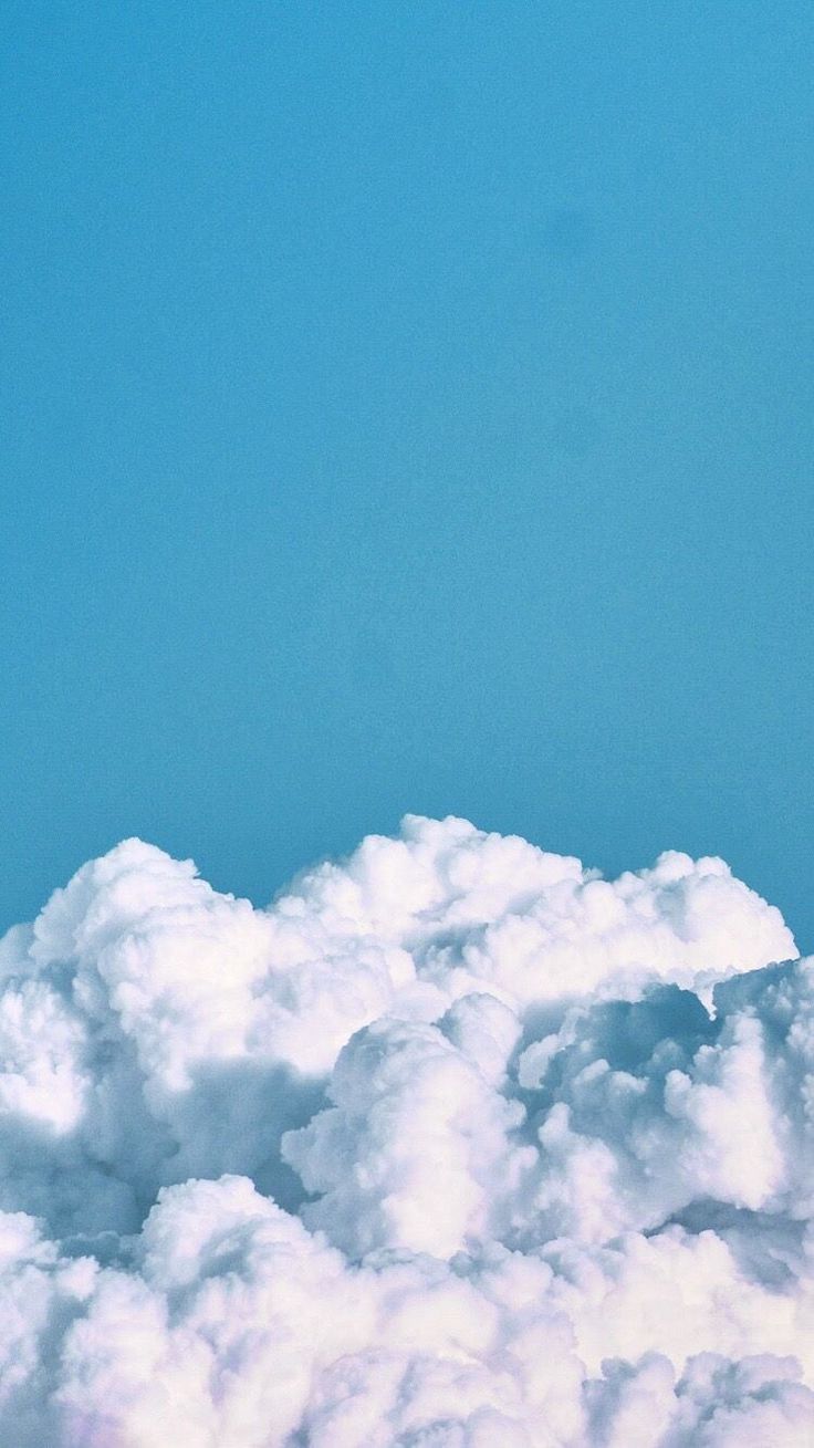 an airplane is flying high above the clouds