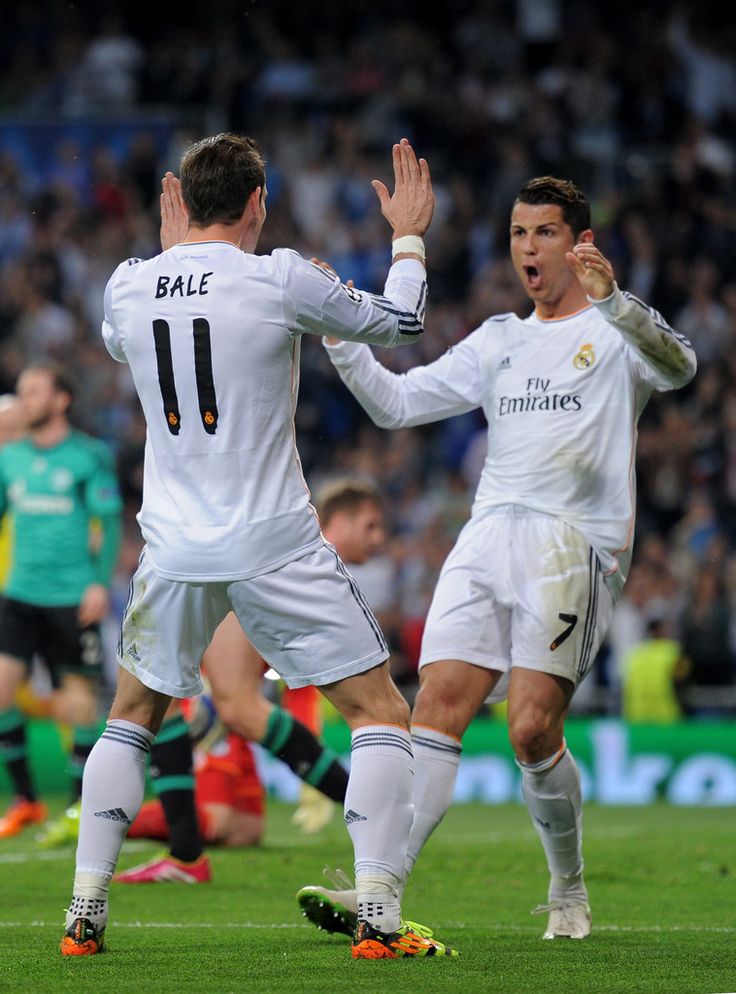 two soccer players are congratulating each other on the field