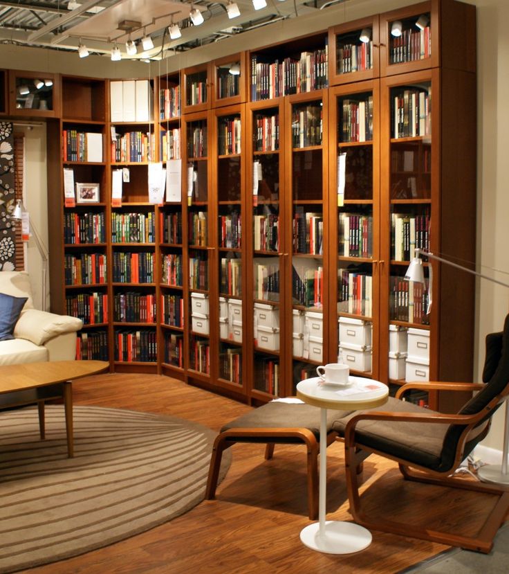 a living room filled with lots of furniture and bookshelves next to each other