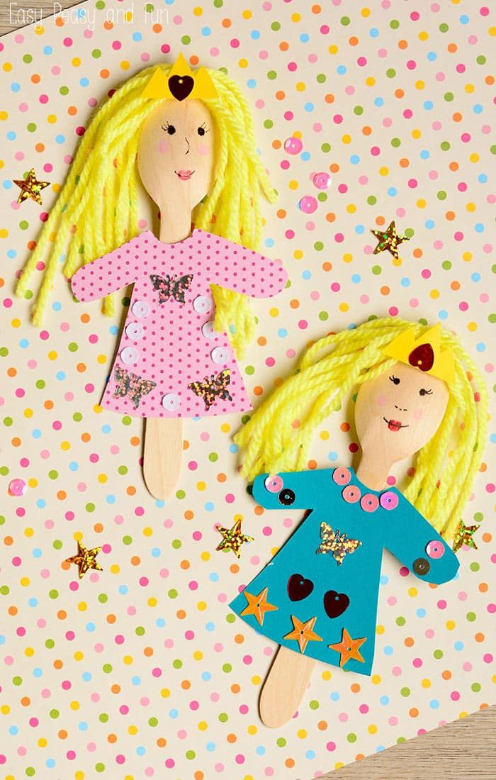 two paper dolls on top of a polka dot background with the caption's facebook page below