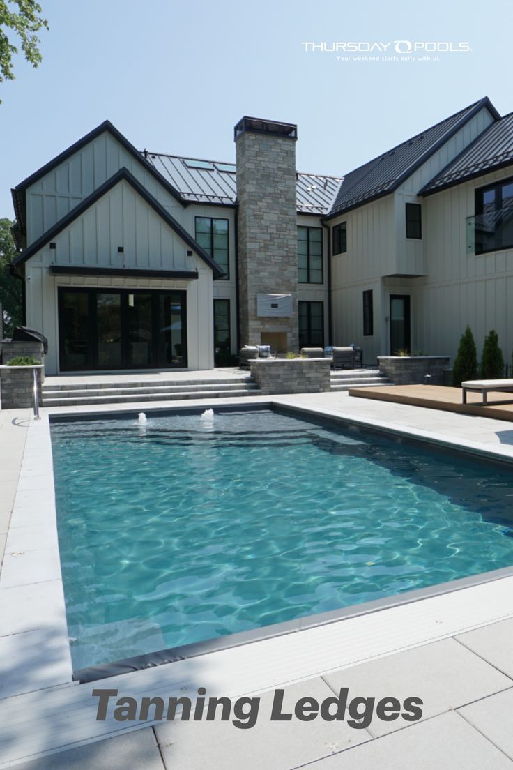 a large swimming pool in front of a house