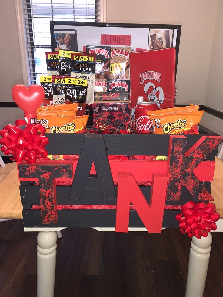 a table that has some candy and candies on it with a red bow around the edge