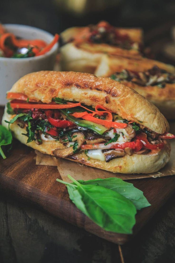 a sub sandwich on a wooden cutting board