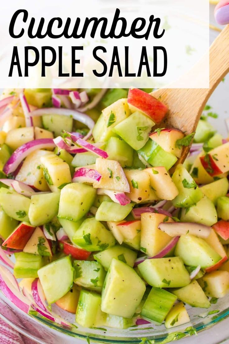 cucumber apple salad in a glass bowl with a wooden spoon and text overlay that reads cucumber apple salad