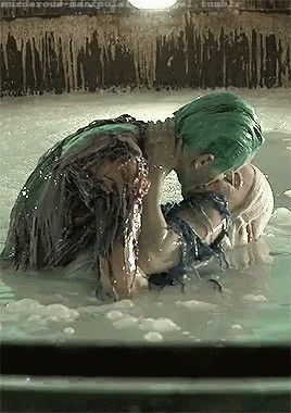 two people are in the water with their heads wrapped around each other and one person is wearing a green turban