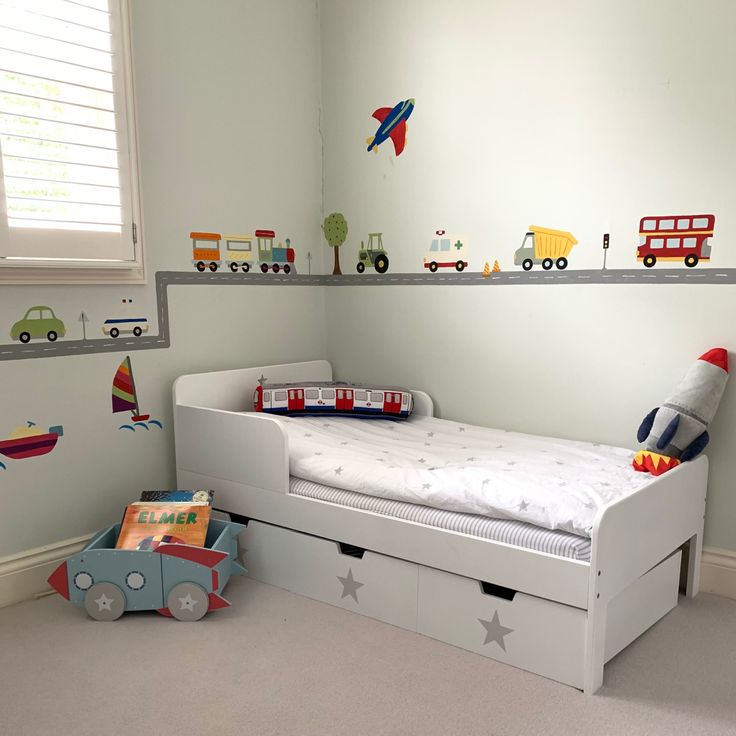 a child's bedroom with toys and decor on the walls