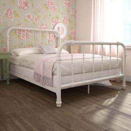 a white bed sitting on top of a wooden floor