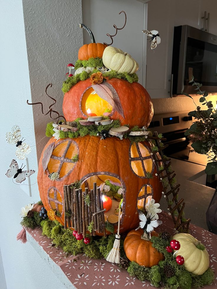 a house made out of pumpkins on a table