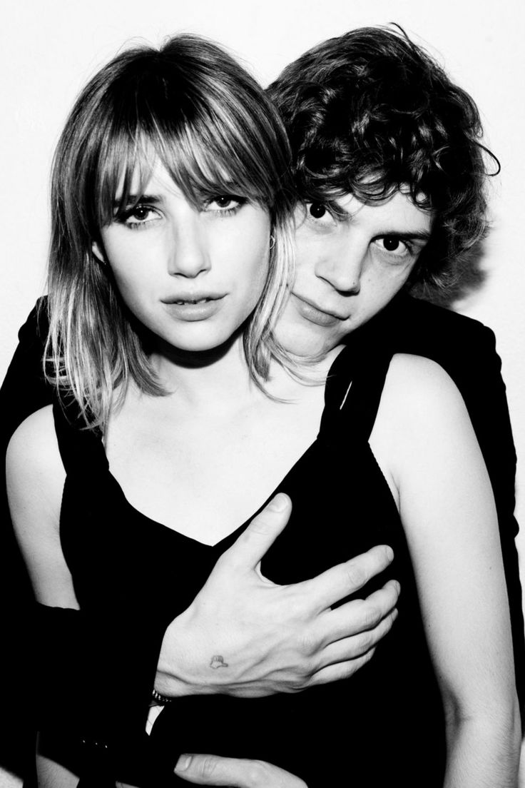 black and white photograph of two people posing for the camera with their arms around each other