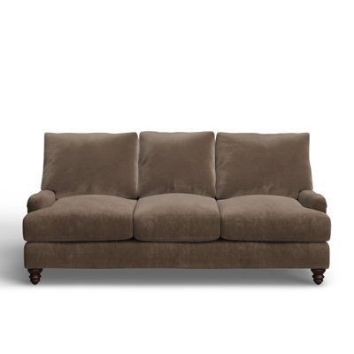 a brown couch sitting on top of a white floor