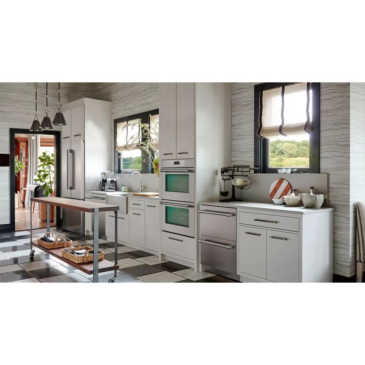 a kitchen with white cabinets and black and white checkered flooring on the walls