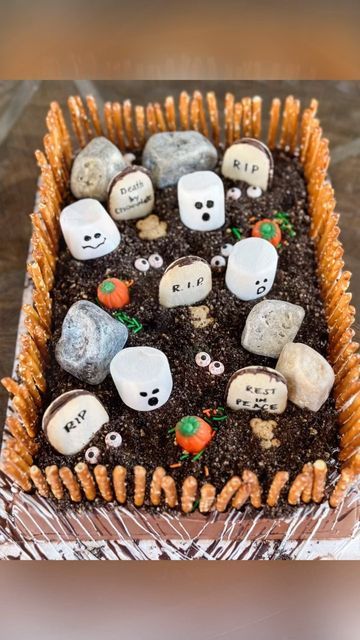 a cake decorated with halloween rocks and bones