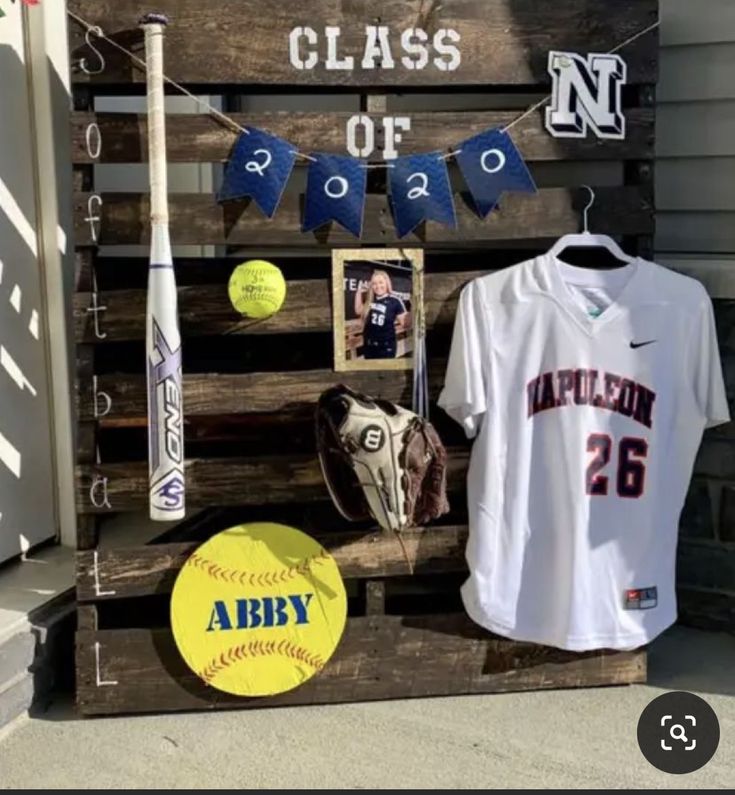 a baseball bat, jersey and helmet are on display in a wooden crate with the name class of 2012