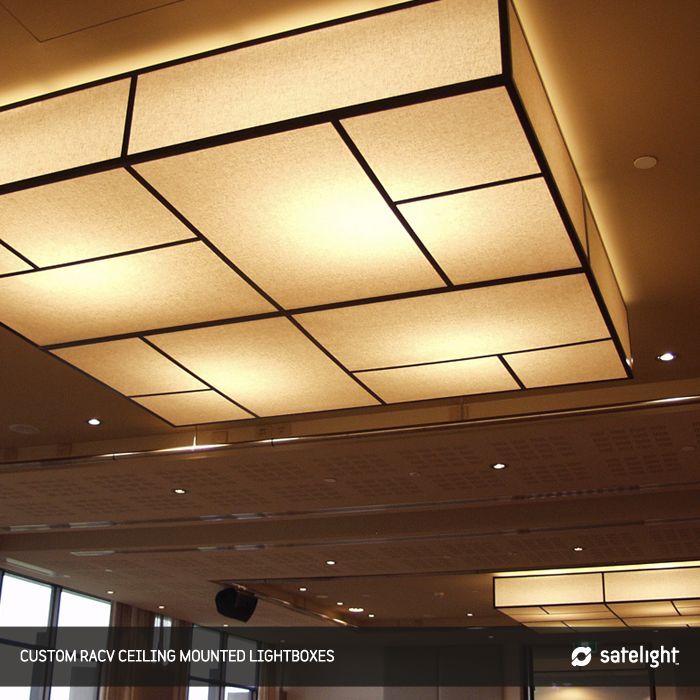 the ceiling in an office building is lit up with dim lighting and square shaped panels