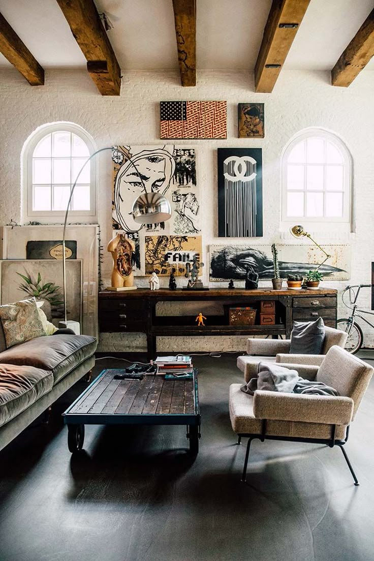 a living room filled with furniture and windows