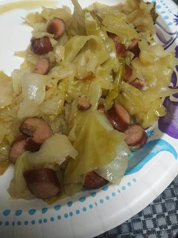 a white plate topped with lots of food on top of a blue and white table