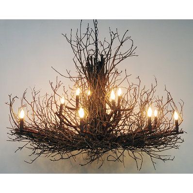 a chandelier made out of branches with lights on it