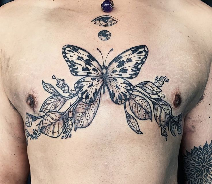 a man with a butterfly tattoo on his chest