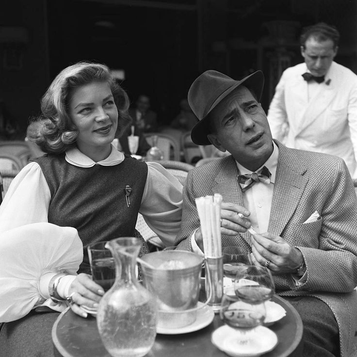 a man and woman sitting at a table together