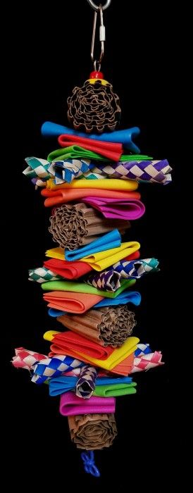 a multicolored key chain hanging from a hook on a black background with an assortment of different colored items