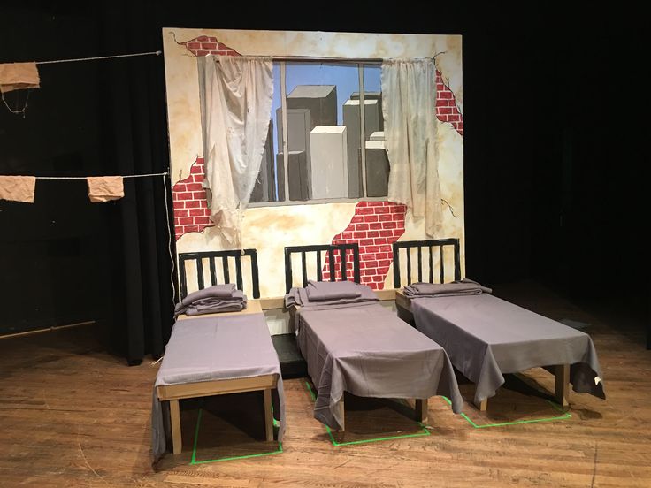 three beds are placed in front of a backdrop