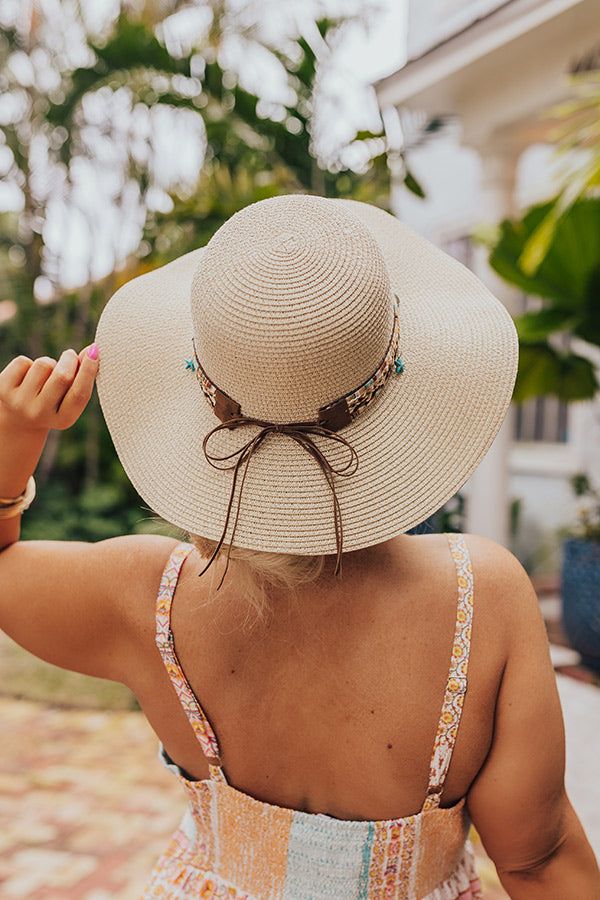 - Live your best beach life with this trendy raffia hat! - Woven material - A woven band featuring browns, peach, and turquoise and a tie detail - Dangling seashell and starfish charms - Hat Dimensions: - Length-16 Inches - Width- 15.5 Inches - Height-4 Inches - Cranial Circumference- 22 Inches - Brim Width- 4 Inches Cream Woven Sun Hat For Vacation, Adjustable Beachy Straw Hat For Poolside, Adjustable Straw Hat For Poolside Beachwear, Beachy Straw Hat For Pool, Beachy Straw Hat For Pool And Beach Season, Adjustable Beachy Sun Hat For Beach Season, Adjustable Summer Straw Hat For The Beach, Bohemian Straw Hat For Vacation Poolside, Natural Color Summer Hat Bands For Beach