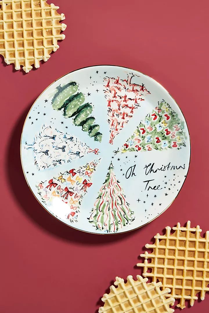 two waffles are next to a plate with christmas trees on it and the words merry