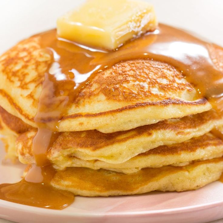 a stack of pancakes covered in syrup and butter