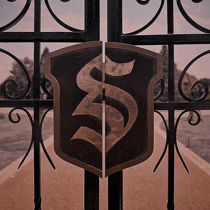 an iron gate with a sign on it that says s & g above the shield