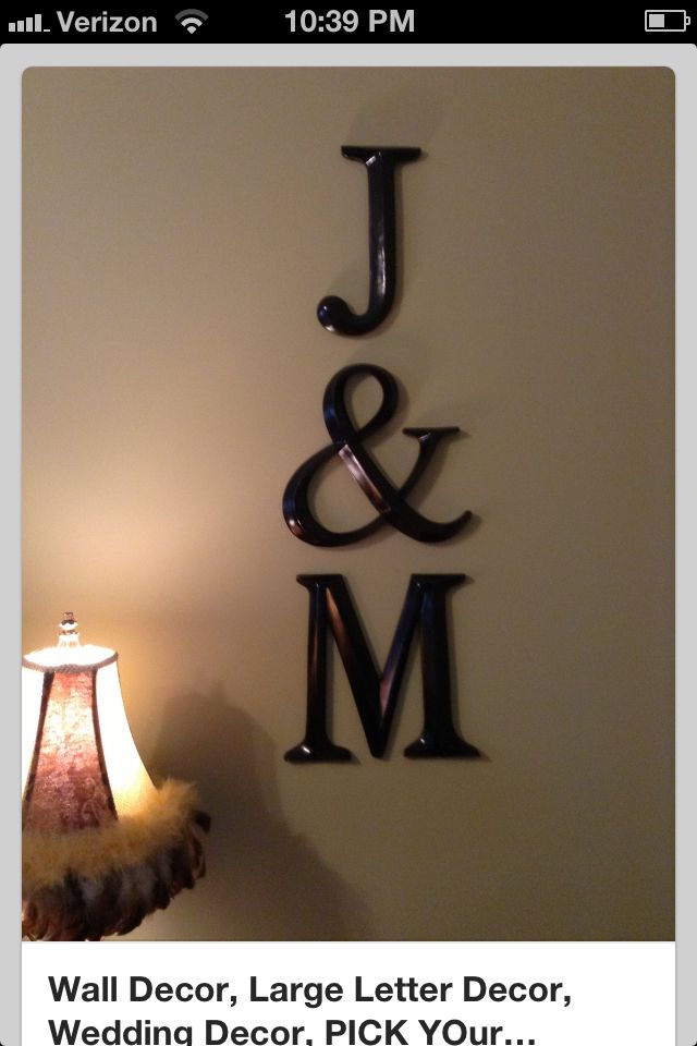 a lamp sitting on top of a table next to a sign that says j and m