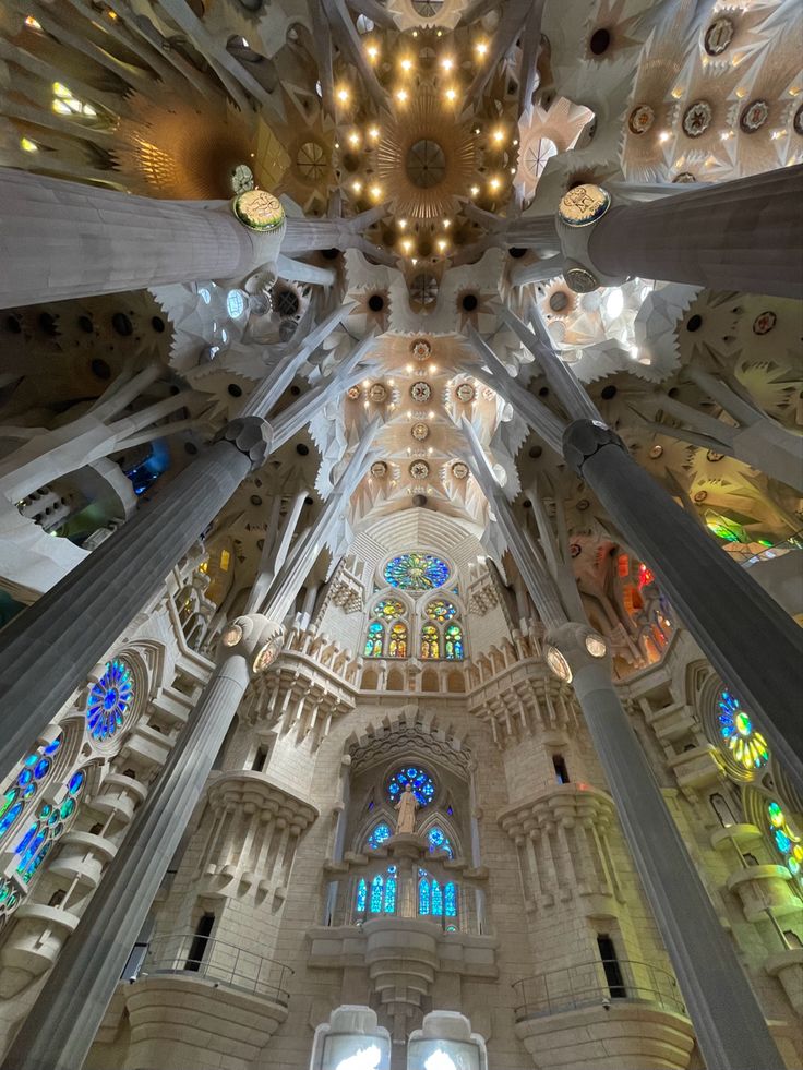 the inside of a building with many windows and lights on each side of the ceiling