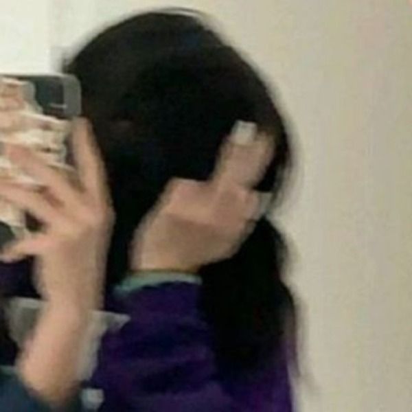 a woman is taking a selfie with her cell phone in front of her face