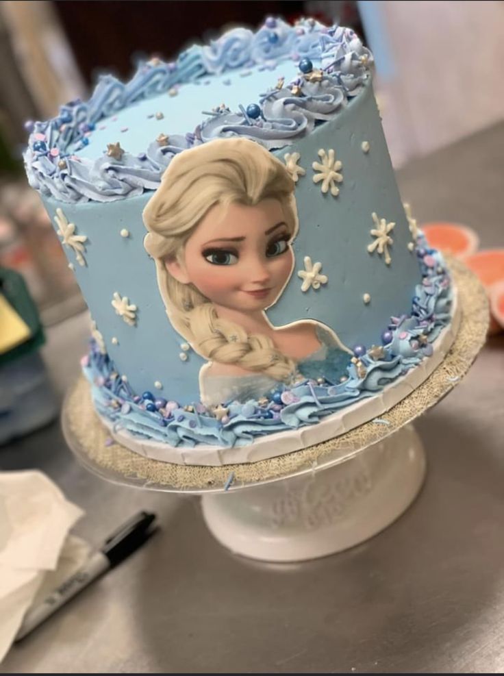 there is a frozen princess cake on the table