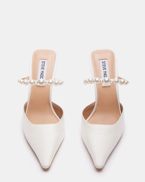 a pair of white high heels with pearls on the heel and ankle straps, all in leather