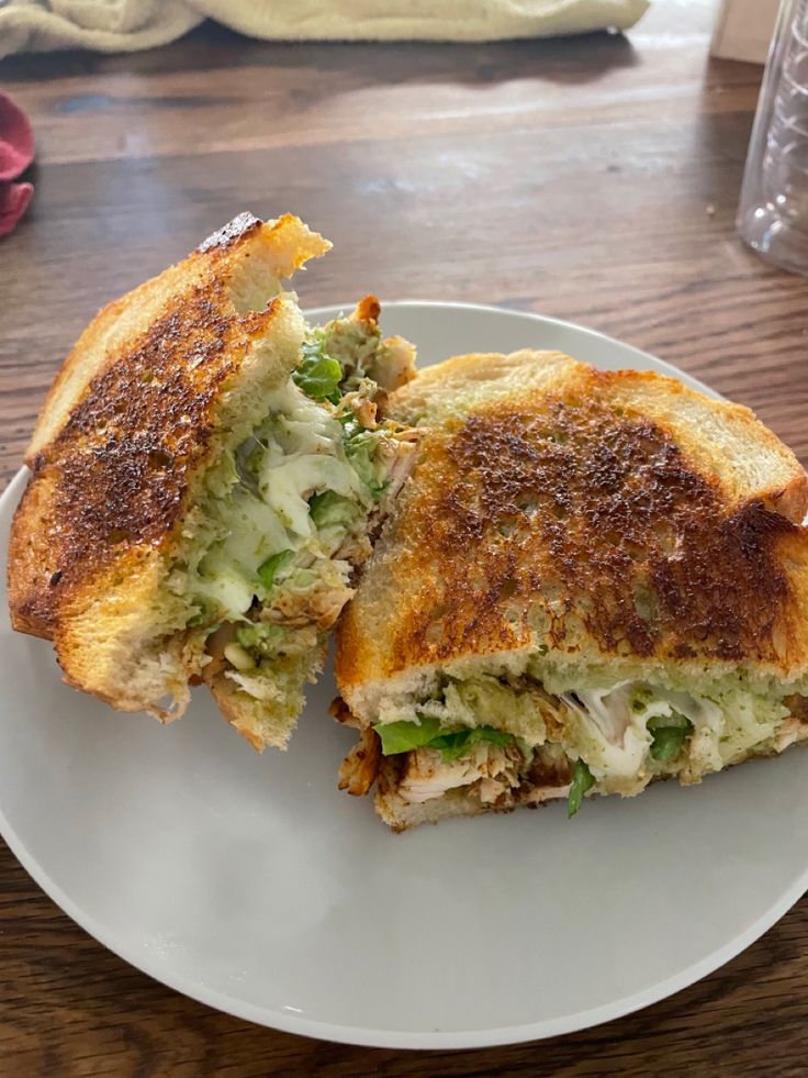 a sandwich cut in half on a white plate